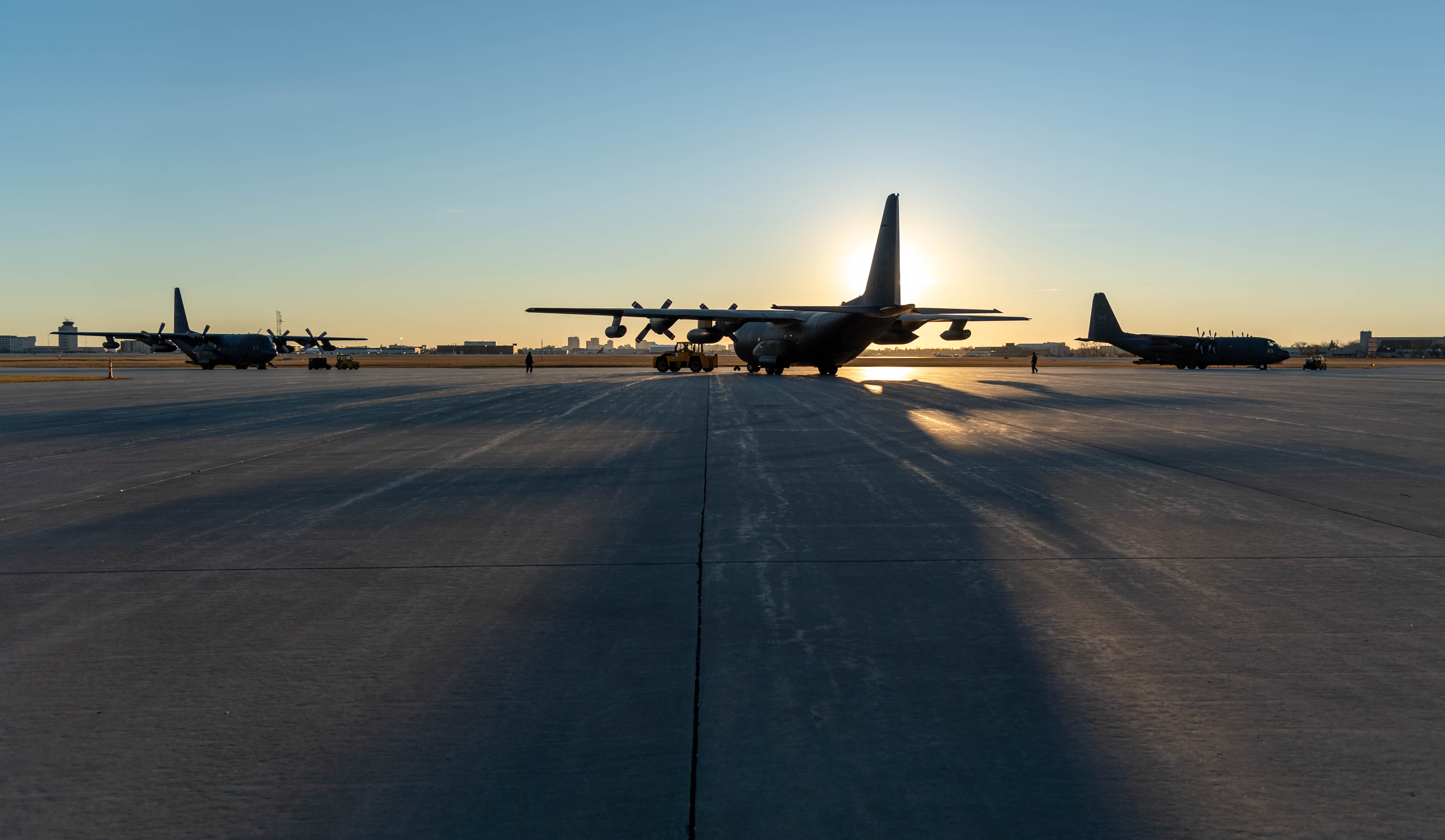 CC-130 Hercules aircraft sit on the tarmac at 17 Wing Winnipeg, Manitoba, at dawn on October 13, 2020, before taking off to fly over Winnipeg to mark the 60th year of service of the aircraft in the Royal Canadian Air Force. PHOTO: Corporal Darryl Hepner